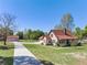 A daytime angle showing the home's facade, long driveway, and large detached garage at 9272 Gotha Rd, Windermere, FL 34786