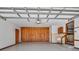 Well-lit garage interior featuring a ceiling fan, ample storage space and easy access to the house at 9272 Gotha Rd, Windermere, FL 34786