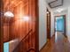 Hallway with wood-paneled wall, leading to carpeted stairs and other rooms at 9272 Gotha Rd, Windermere, FL 34786