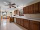 Functional kitchen with wood cabinets, white appliances and views to adjacent areas at 9272 Gotha Rd, Windermere, FL 34786