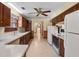 Classic kitchen with wood cabinets, white appliances, and plenty of counter space at 9272 Gotha Rd, Windermere, FL 34786