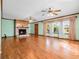 Inviting living room with hardwood floors, stone fireplace, and abundant natural light at 9272 Gotha Rd, Windermere, FL 34786