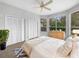 Bright bedroom with natural light, double closets, plush bedding, and serene views from the large windows at 9700 Sw 194Th Cir, Dunnellon, FL 34432