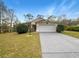 Charming single-story home featuring a well-maintained lawn, a two-car garage, and a neutral color palette at 9700 Sw 194Th Cir, Dunnellon, FL 34432