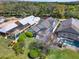 Aerial view of luxury homes with screened-in pools, surrounded by manicured lawns and mature trees at 10148 Chiltern Garden Dr, Orlando, FL 32827