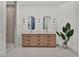 Modern bathroom featuring a dual sink vanity with wood drawers, stylish mirrors and sconces at 10148 Chiltern Garden Dr, Orlando, FL 32827