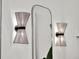 Stylish bathroom sconces create a warm ambiance, reflected in the mirror's elegant design at 10148 Chiltern Garden Dr, Orlando, FL 32827