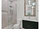 Modern bathroom featuring a glass shower, and a vanity with a stylish mirror and unique lighting at 10148 Chiltern Garden Dr, Orlando, FL 32827
