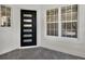 Modern front entry with a stylish black door, sidelight windows and brick-paved porch at 10148 Chiltern Garden Dr, Orlando, FL 32827