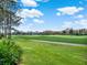 Scenic golf course panorama showcases the manicured green and distant luxury homes under a blue sky at 10148 Chiltern Garden Dr, Orlando, FL 32827