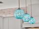 Close-up of the kitchen's stylish blue pendant lights adding a pop of color at 10148 Chiltern Garden Dr, Orlando, FL 32827