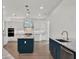 Spacious kitchen with white cabinetry, marble countertops, blue island, and stainless steel appliances at 10148 Chiltern Garden Dr, Orlando, FL 32827