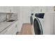 Laundry room features custom cabinets, granite countertops, modern appliances, and tiled floors at 10148 Chiltern Garden Dr, Orlando, FL 32827