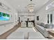 Inviting living room featuring a decorative chandelier, stylish seating, and open layout to the kitchen at 10148 Chiltern Garden Dr, Orlando, FL 32827