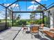 Relaxing screened patio area with outdoor seating, perfect for enjoying views of the lush landscaping at 10148 Chiltern Garden Dr, Orlando, FL 32827