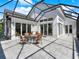 Inviting screened patio features a dining table and chairs, ideal for outdoor entertaining and relaxing at 10148 Chiltern Garden Dr, Orlando, FL 32827