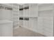 Spacious walk-in closet features built-in shelving and ample storage space for clothes and accessories at 10148 Chiltern Garden Dr, Orlando, FL 32827