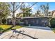 Charming single-story home with a modern horizontal screened door and an extra-long driveway at 1018 Wentrop Ln, Orlando, FL 32804