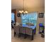 Dining area featuring a chandelier, large window and a neutral color scheme at 10333 Crystal Point Dr, Orlando, FL 32825