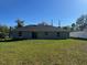 Spacious backyard featuring a well-maintained lawn and views of the neighborhood at 1055 W French Ave, Orange City, FL 32763