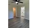 Bedroom with a view to the bathroom and walk-in closet, ceiling fan and gray flooring at 1055 W French Ave, Orange City, FL 32763