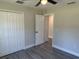 Bedroom with ceiling fan, closet, gray vinyl flooring, and natural lighting at 1055 W French Ave, Orange City, FL 32763