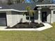 Charming single-story home with a well-manicured lawn and modern architectural details at 1055 W French Ave, Orange City, FL 32763