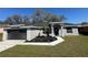 Charming single-story home with a well-manicured lawn and modern architectural details at 1055 W French Ave, Orange City, FL 32763