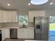 Modern kitchen with stainless steel appliances, white cabinetry, and hardwood flooring at 1055 W French Ave, Orange City, FL 32763