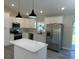 Bright kitchen features stainless steel appliances, center island and pendant lighting at 1055 W French Ave, Orange City, FL 32763