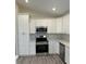 Well-lit kitchen featuring modern stainless steel appliances and white cabinetry at 1055 W French Ave, Orange City, FL 32763