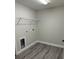 Laundry area with gray vinyl flooring and a shelf above the washer hookups at 1055 W French Ave, Orange City, FL 32763