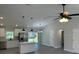 Open-concept living room with hardwood floors, an island, and stainless steel appliances at 1055 W French Ave, Orange City, FL 32763