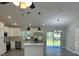 Open-concept living room with hardwood floors, an island, and stainless steel appliances at 1055 W French Ave, Orange City, FL 32763