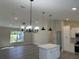 Open-concept living room with modern lighting, hardwood floors, and neutral paint at 1055 W French Ave, Orange City, FL 32763
