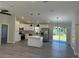Open-concept living room with hardwood floors, an island, and stainless steel appliances at 1055 W French Ave, Orange City, FL 32763