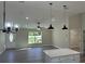 Open-concept living room with modern lighting, hardwood floors, and neutral paint at 1055 W French Ave, Orange City, FL 32763