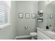 Charming powder room with decorative art and modern fixtures, offering a stylish and functional space at 11844 Pulitzer Pl, Orlando, FL 32832