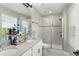 Beautiful bathroom with a double vanity and a glass-enclosed shower, providing luxury and convenience at 11844 Pulitzer Pl, Orlando, FL 32832