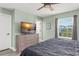Cozy bedroom with a ceiling fan, a large window and a view offering a peaceful retreat at 11844 Pulitzer Pl, Orlando, FL 32832