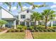 Charming two-story home with manicured lawn, lush landscaping and brick walkway at 11844 Pulitzer Pl, Orlando, FL 32832