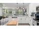 Modern kitchen with a large island and seamless flow into the living area at 11844 Pulitzer Pl, Orlando, FL 32832