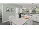 Large kitchen island with counter seating, view of living spaces, and stylish finishes at 11844 Pulitzer Pl, Orlando, FL 32832