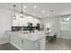 Bright kitchen boasts a spacious island, modern pendant lights, and stainless steel appliances at 11844 Pulitzer Pl, Orlando, FL 32832