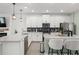 Modern kitchen with a large island, stainless steel appliances, and white cabinets at 11844 Pulitzer Pl, Orlando, FL 32832