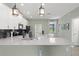 Bright kitchen featuring a large island, modern appliances, and backyard view at 11844 Pulitzer Pl, Orlando, FL 32832
