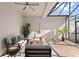 Covered lanai features brick flooring, comfortable seating area and potted plants at 11844 Pulitzer Pl, Orlando, FL 32832