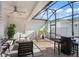 Covered lanai features brick flooring, ceiling fan, and comfortable seating area at 11844 Pulitzer Pl, Orlando, FL 32832