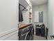 Convenient laundry room with washer, dryer, built-in shelving, and modern fixtures at 11844 Pulitzer Pl, Orlando, FL 32832