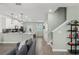 Open-concept living room with modern finishes, stairs, and seamless flow into the kitchen at 11844 Pulitzer Pl, Orlando, FL 32832
